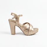 Gold high-heeled shoe on a white background